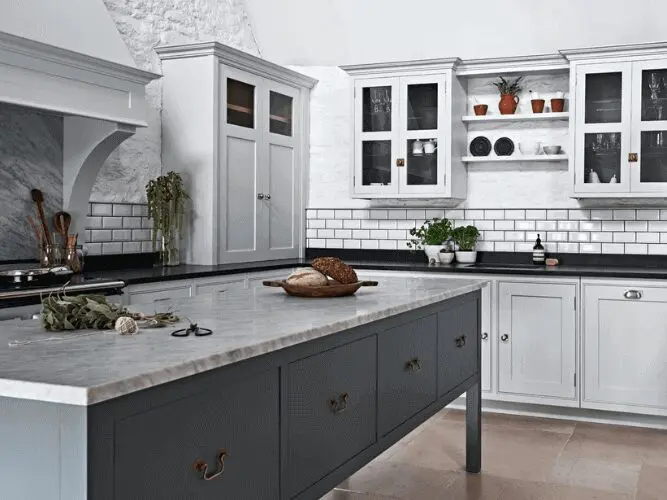 Angled shot of grey kitchen units with white marble work tops