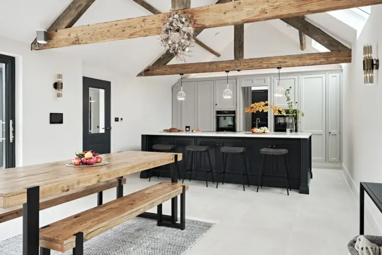 Long angled shot of a contemporary kitchen with white marble tops