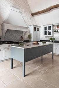 Green kitchen island with grey marble surface
