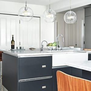 Black kitchen units with white marble surfaces