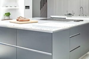 Grey kitchen units with white marble surface
