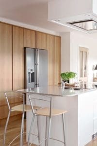 Modern kitchen with bespoke fitted storage and marble surfaces