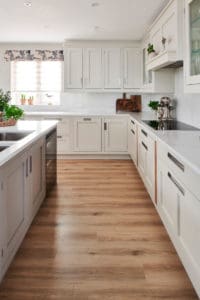 White kitchen units with white marble surfaces
