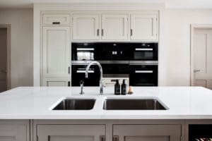 Grey kitchen units with white marble surface