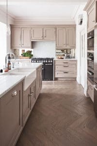 Bespoke kitchen with parquet flooring and white marble surfaces