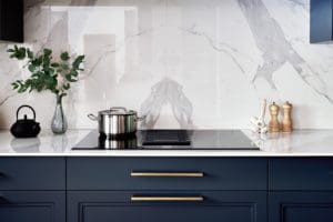 Dark navy units and white marble surfaces