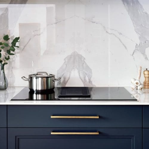 Dark navy units and white marble surfaces