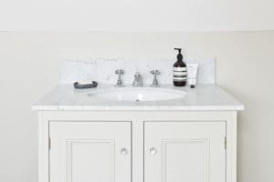 Off white storage with white marble sink surface