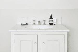 Off white storage with white marble sink surface