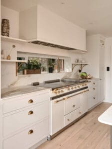 White kitchen units with marble surfaces