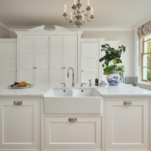 White kitchen units with white marble surfaces