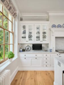 White kitchen storage with white marble surfaces